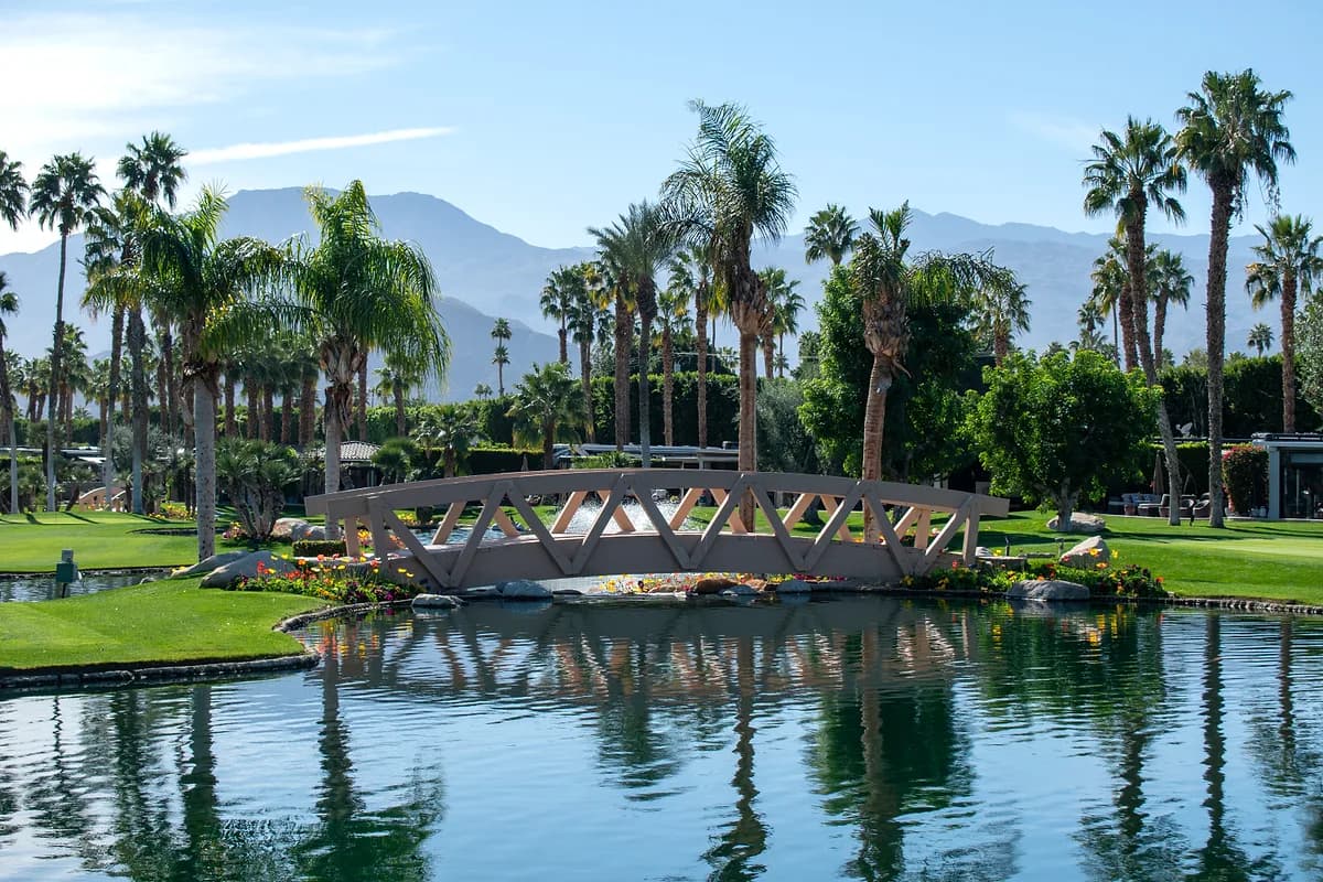 Decorative bridge with mountain backdrop and reflections