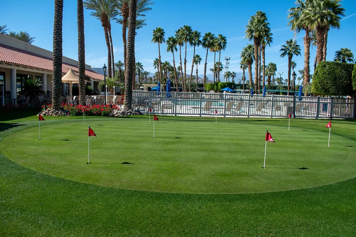 Putting green with pool area in background
