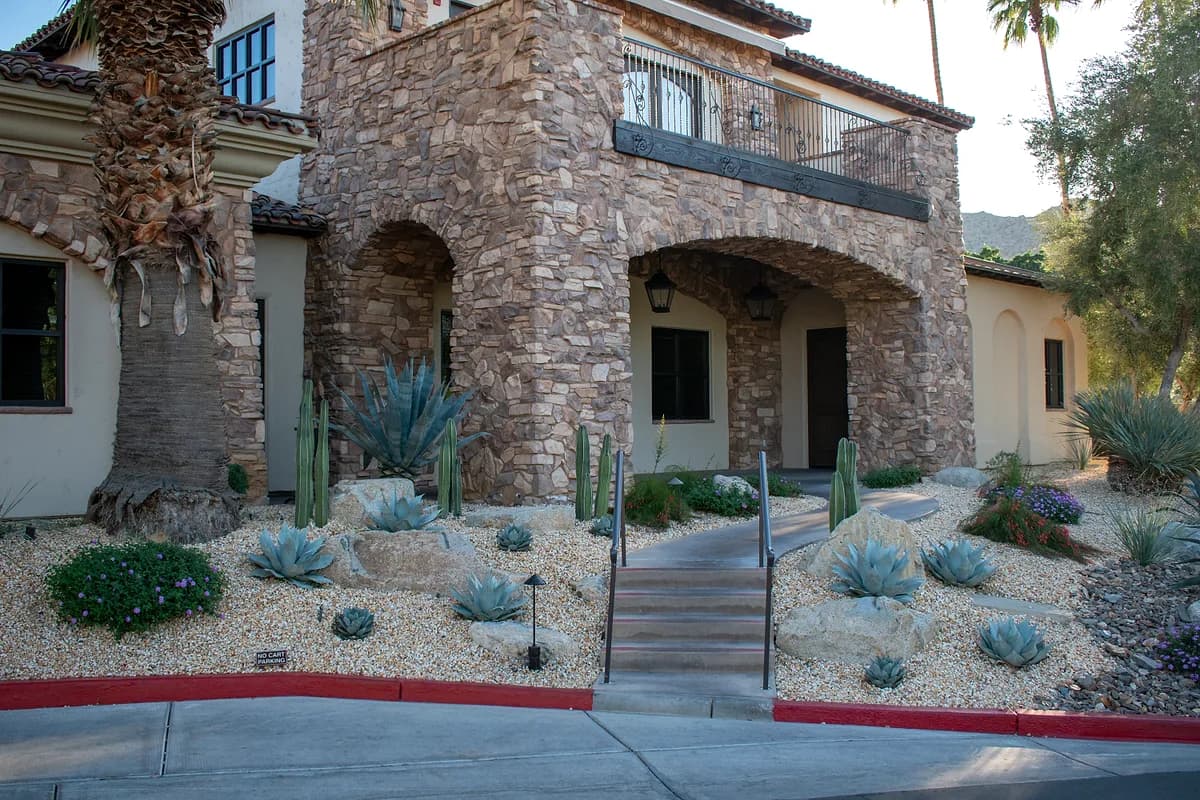 Stone entrance with blue agaves and cacti