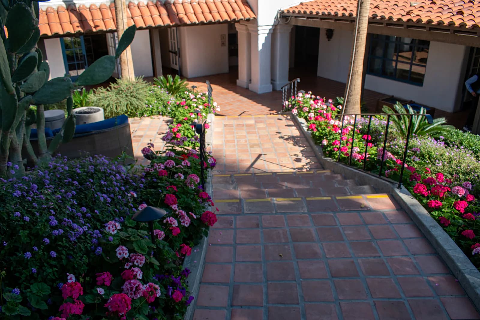 Flower beds along tiled courtyard
